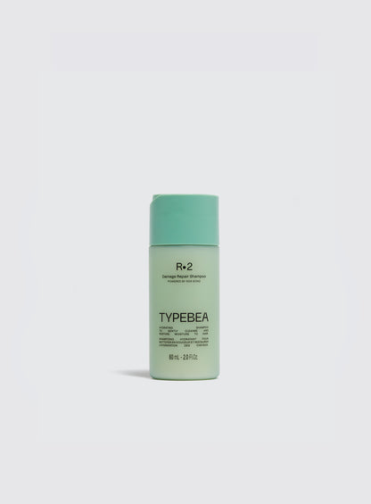 Green bottle of Typebea hair product on a white background